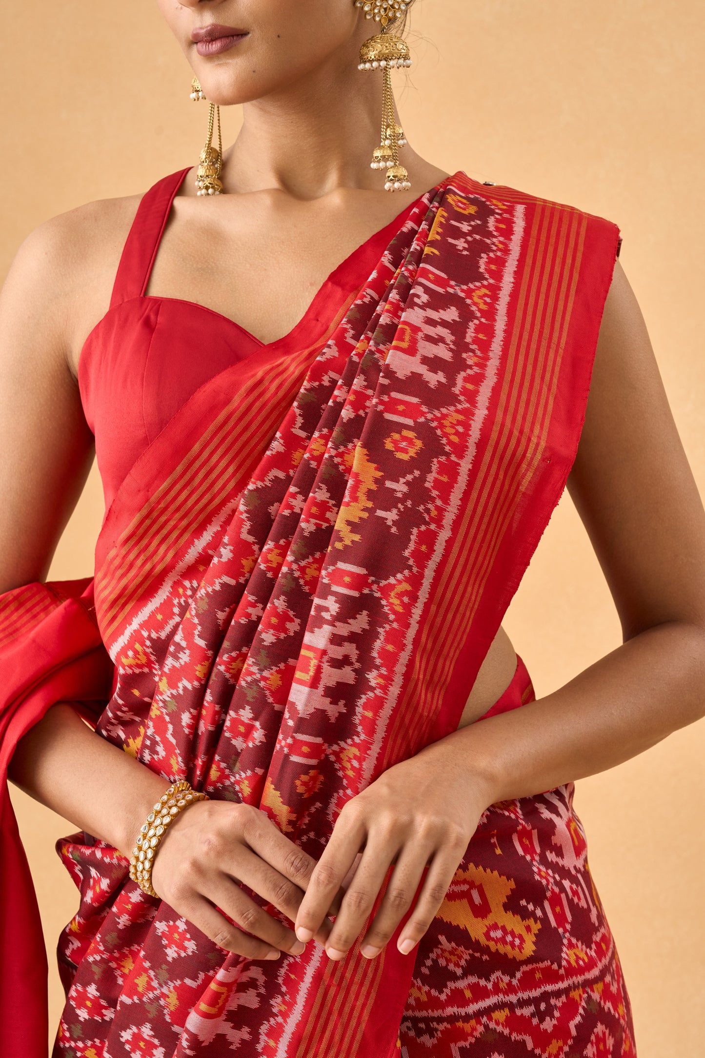 Crimson Red Patola Silk Weave Saree With Golden Zari Piping