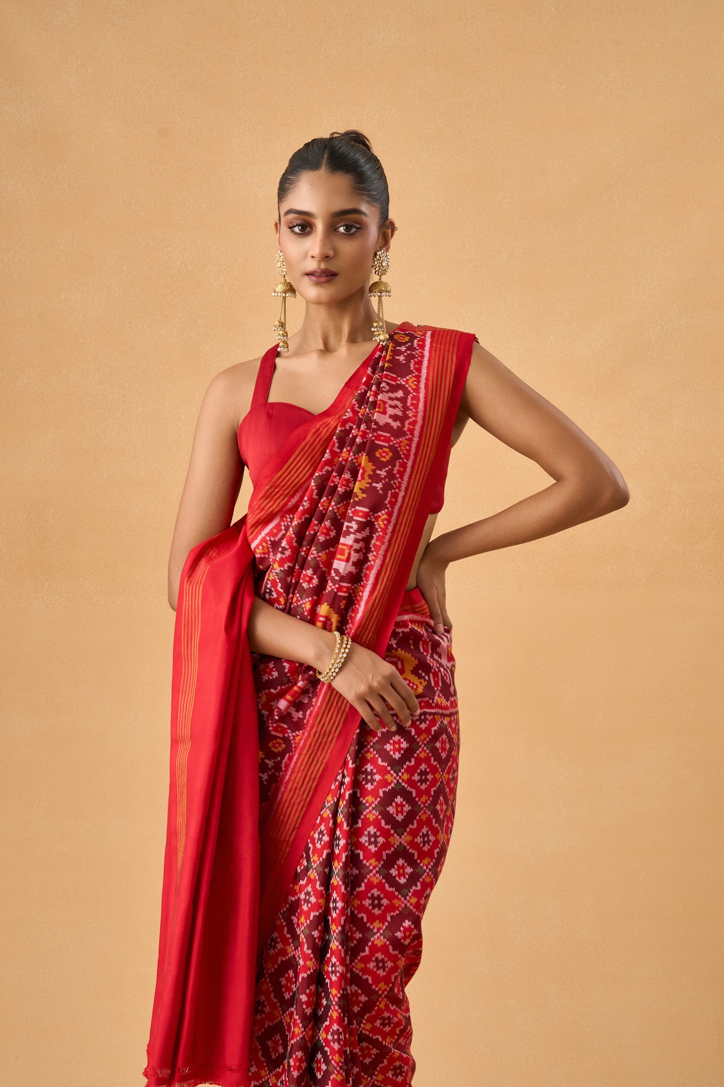 Crimson Red Patola Silk Weave Saree With Golden Zari Piping