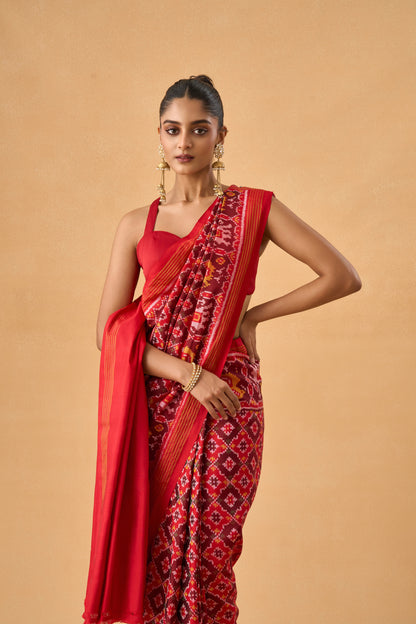 Crimson Red Patola Silk Weave Saree With Golden Zari Piping